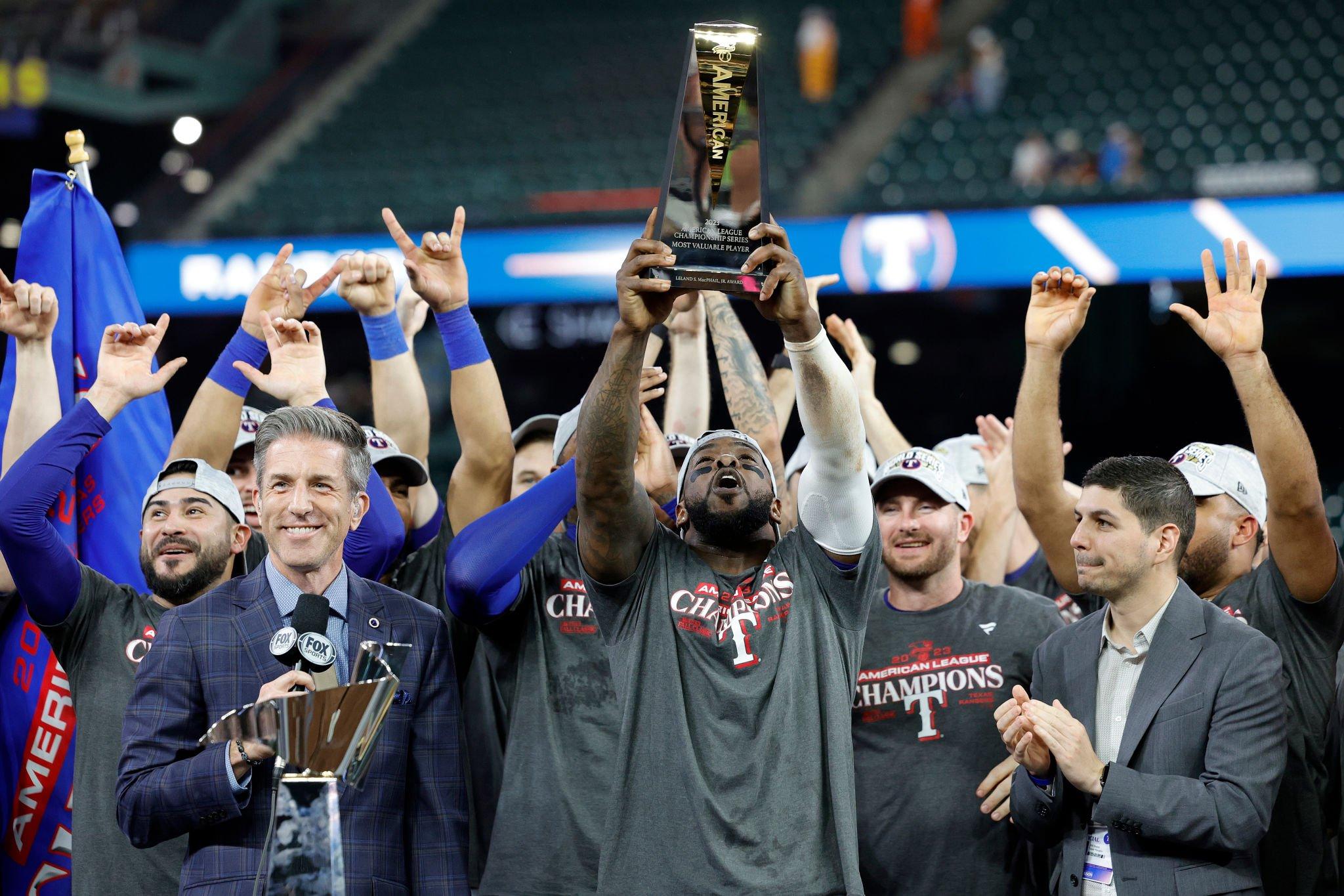 Texas Rangers team celebrating with the ALCS trophy after defeating the Houston Astros, advancing to the 2023 World Series.