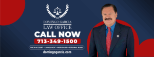 Attorney Domingo Garcia stands beside official sponsorship banner with contact info for personal injury law services